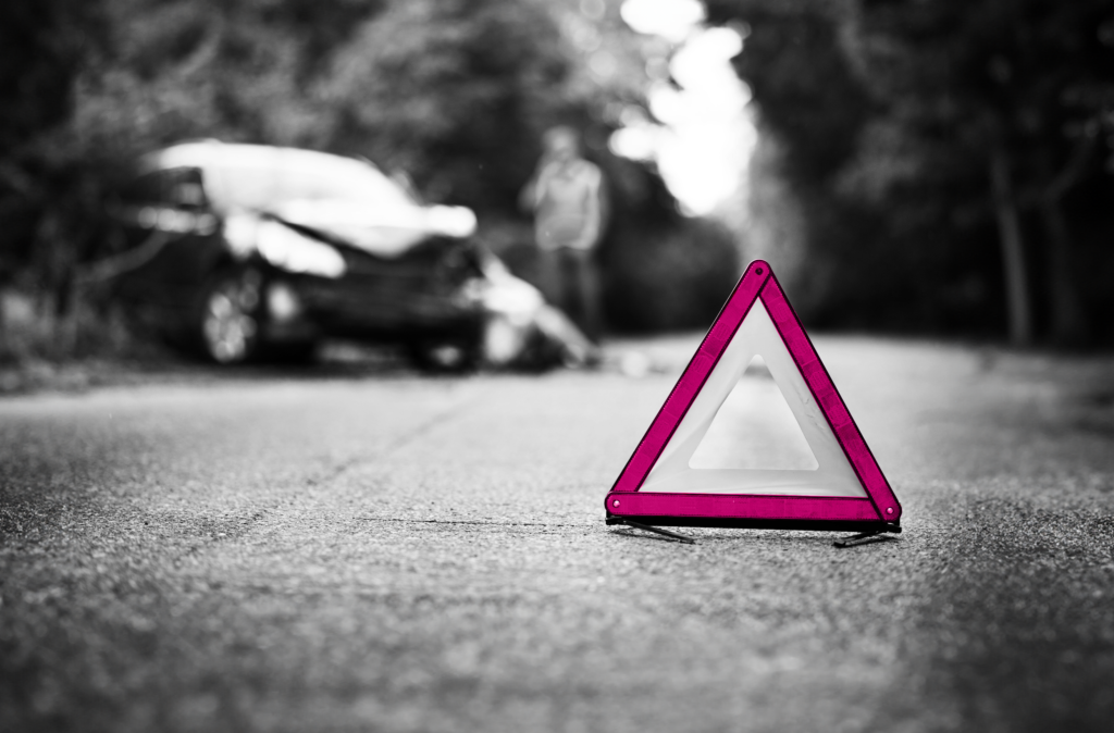 Car crash with warning sign in front