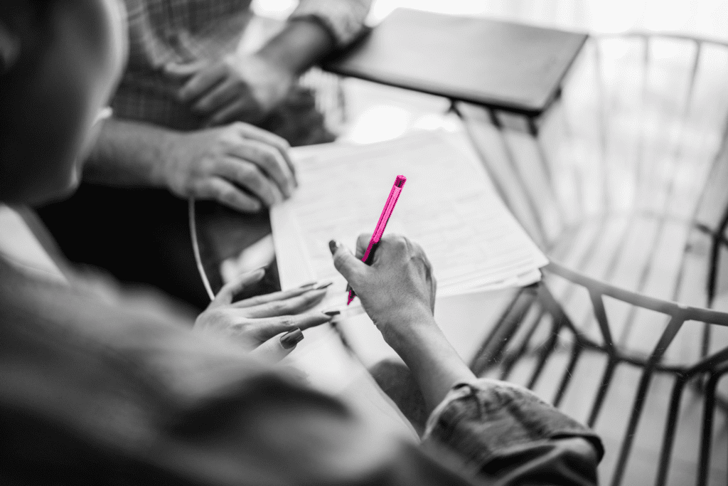 young woman signing a paper