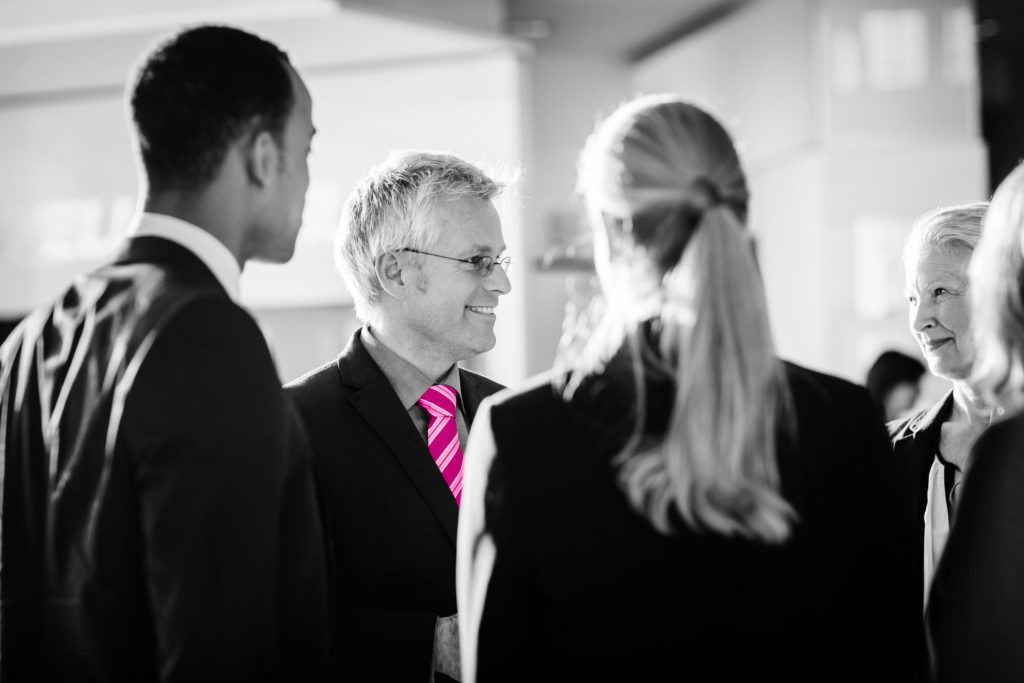 group of professionals having a discussion in an office