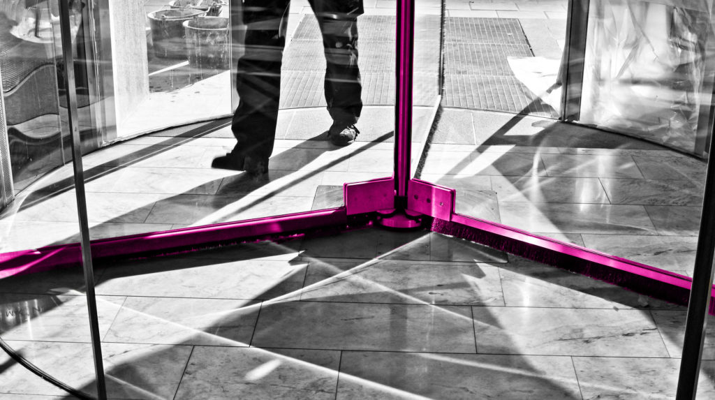 man going through a revolving door
